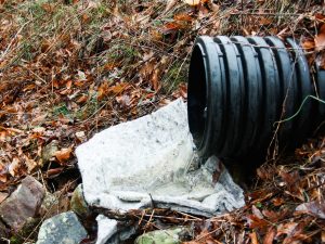 Husky Rug and Pads below black culvert pipe