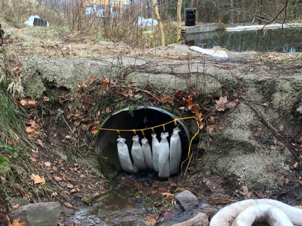 SkimBoa in Culvert cleaning up oil fuel spill on water